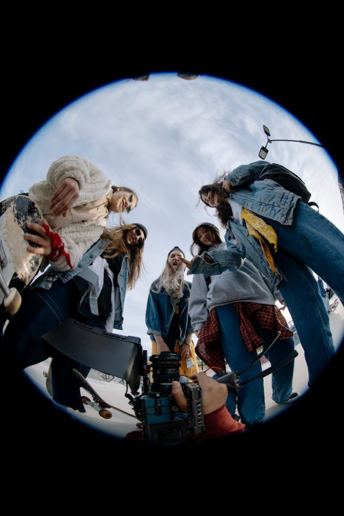 pexels-photo-10117929 Young women skaters captured through a fisheye lens showcasing friendship and teamwork outdoors.